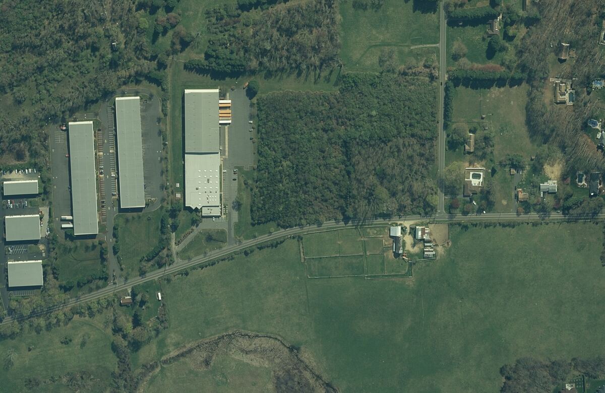 Top-down aerial of 317 Fairfield Road with the two lots outlined: Lot 123 with the warehouse building, and Lot 123.01 at the corner of Fairfield Road and Merrick Road